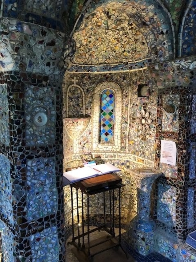 A glimpse through the chapel’s narrow entrance, showcasing its unique structure.