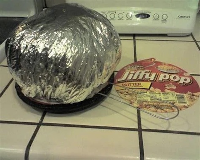 Jiffy Pop popcorn in full action—foil puffed and ready for family movie nights, a retro tradition that never gets old