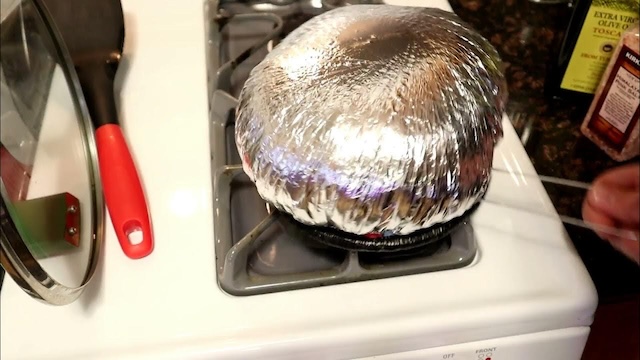 The magic of foil-wrapped popcorn heating over the stove, bringing excitement and anticipation to the kitchen