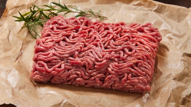 Fresh, uncooked ground beef, ready to be transformed. Its fat content and preparation can greatly impact the texture and flavor of the dish