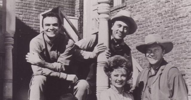 The iconic cast of Gunsmoke in an early behind-the-scenes photo, capturing the camaraderie that would keep audiences captivated for two decades