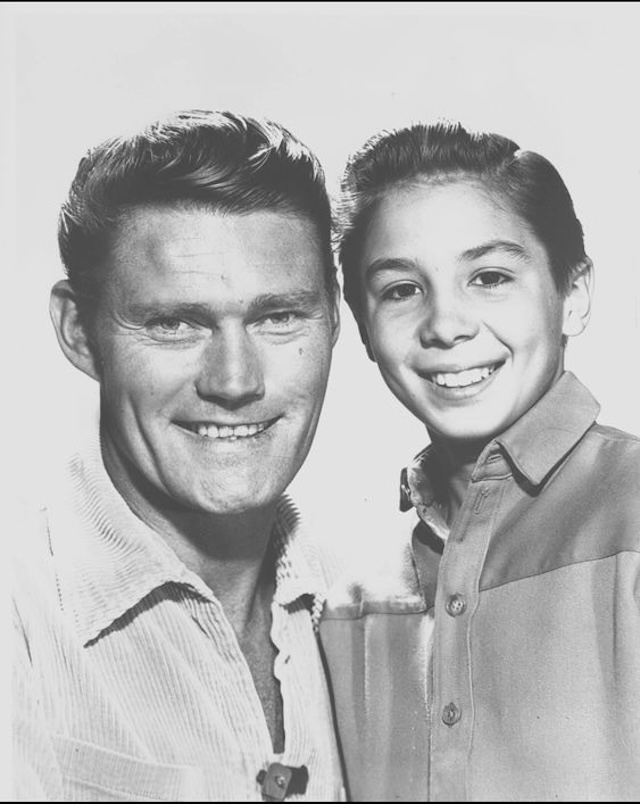 A memorable father-son duo from The Rifleman, Johnny Crawford (right) as Mark McCain and Chuck Connors (left) as Lucas McCain