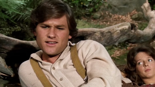 A young Kurt Russell portrays a cowboy in an intense scene from Gunsmoke, showcasing his early Western roles before his Hollywood stardom.