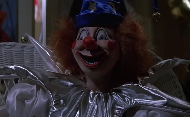 The sinister clown doll sits ominously, adding to the chilling suspense and horror of "Poltergeist.