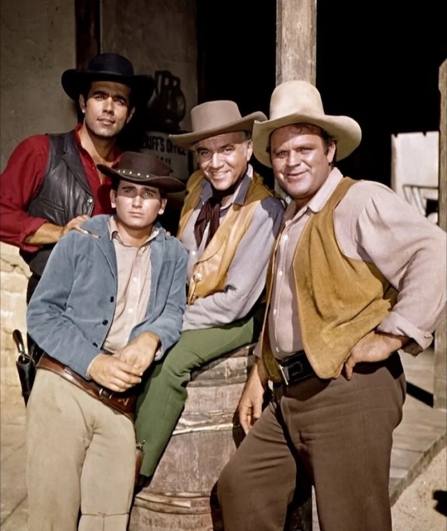  A vibrant shot of the Cartwright family — Little Joe (Michael Landon), Hoss (Dan Blocker), Ben (Lorne Greene), and Adam (Pernell Roberts). Together, they faced numerous challenges while managing their sprawling ranch, the Ponderosa