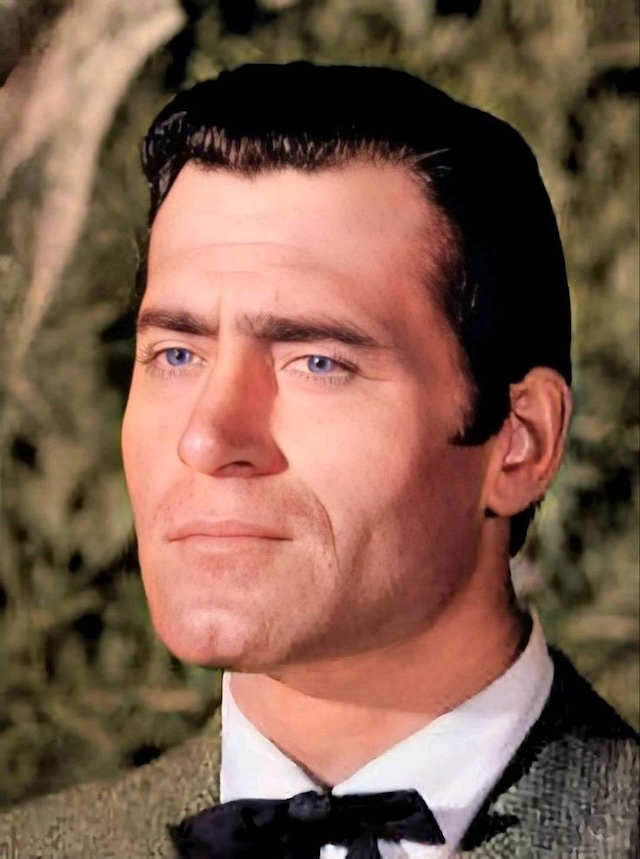 A close-up of Clint Walker, highlighting his striking blue eyes and chiseled features, embodying the classic Hollywood leading man of the 1950s and 60s