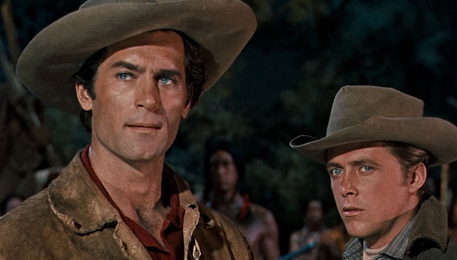 Clint Walker as Yellowstone Kelly, standing strong as the silent protector in the harsh, yet beautiful, Western landscape.