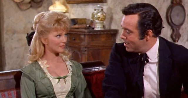 Kathie Browne as Laura Dayton and Pernell Roberts as Adam Cartwright in an intimate scene, portraying their developing relationship on Bonanza.