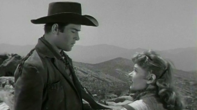 Clint Walker, in one of the show's early episodes, sharing a scene with a guest star while embodying the calm and rugged character of Cheyenne Bodie