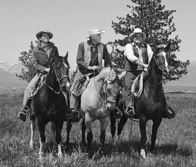 The Cartwright men from Bonanza—Joe, Ben, and Hoss—on horseback, riding through the fields. Their confident poses and the open landscape emphasize their rancher lifestyle