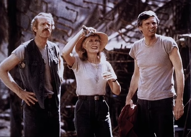 Loretta Swit, Alan Alda, and David Ogden Stiers share a moment on the set of M*A*S*H, portraying the camaraderie that mirrored both the cast's off-screen friendship and their on-screen roles during the Korean War in this iconic series