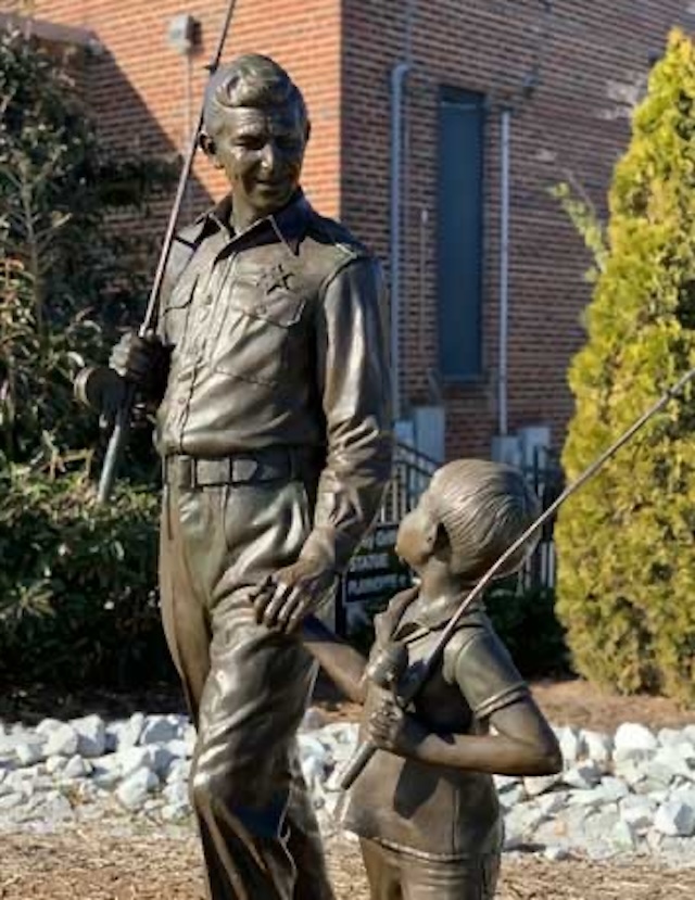 The famous bronze statue of Andy Taylor and Opie, depicting the father and son duo heading to the fishing hole, located in Mount Airy, Andy Griffith’s hometown