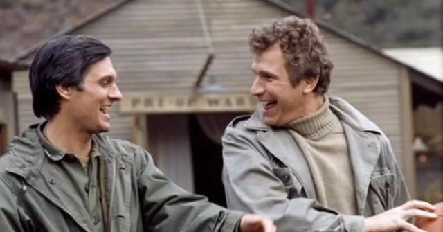 Trapper John and Hawkeye, portrayed by Wayne Rogers and Alan Alda, sharing a moment of laughter and camaraderie amidst the harsh realities of war