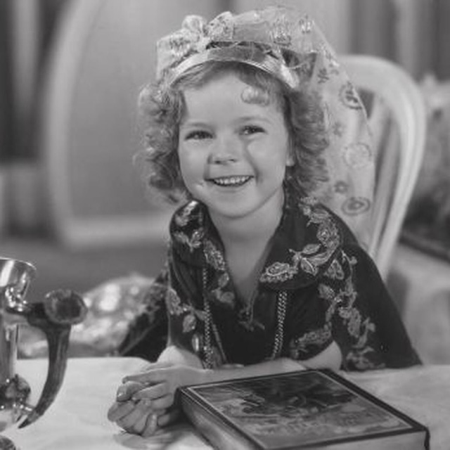 A heartwarming behind-the-scenes image of Shirley Temple, capturing her boundless joy and the genuine spirit she brought to the screen