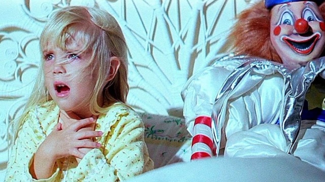 Heather O'Rourke as Carol Anne Freeling, encountering the eerie clown in "Poltergeist," showcasing the film's haunting visuals