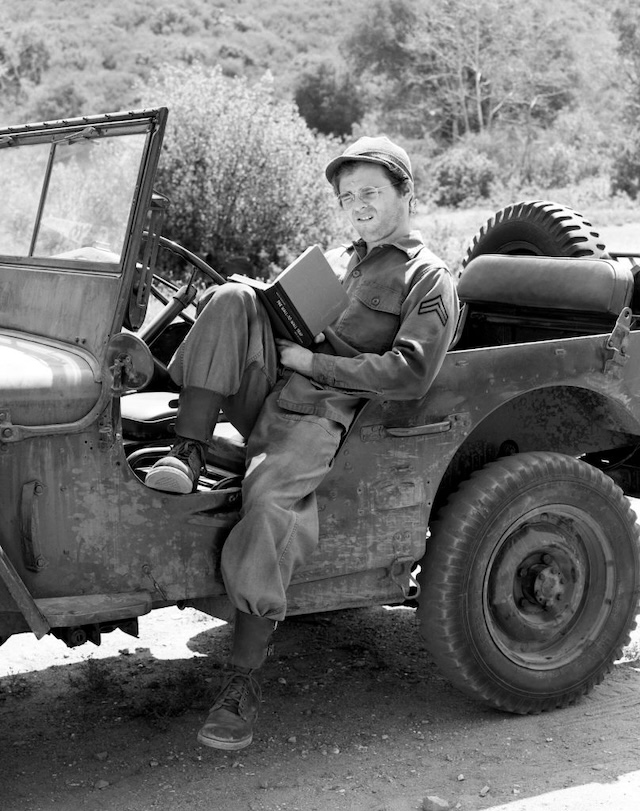 Relaxing in between duties, Radar takes a break with a book in the iconic military jeep, capturing his quiet and introspective nature.