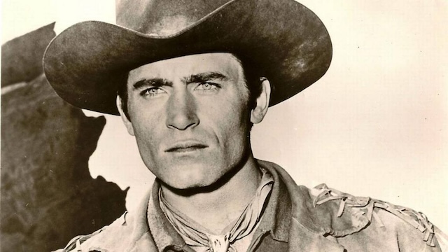 Clint Walker’s steely expression captures the essence of the rugged cowboy spirit in this classic shot.