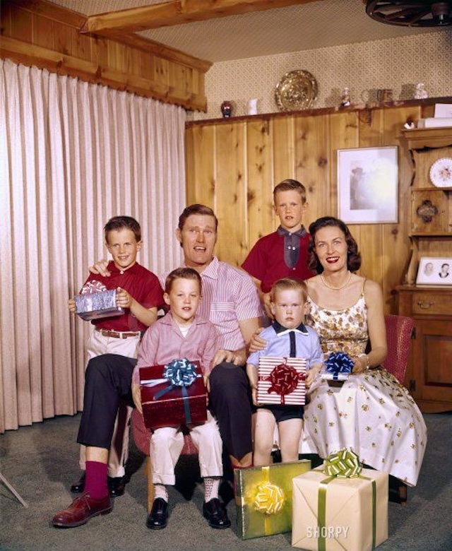 Chuck Connors and his family celebrate a special occasion, surrounded by wrapped gifts, in this classic family portrait