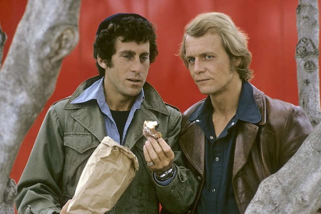 Partners in crime-fighting, Starsky and Hutch, as they share a quiet moment between missions, proving that their bond extends beyond the job