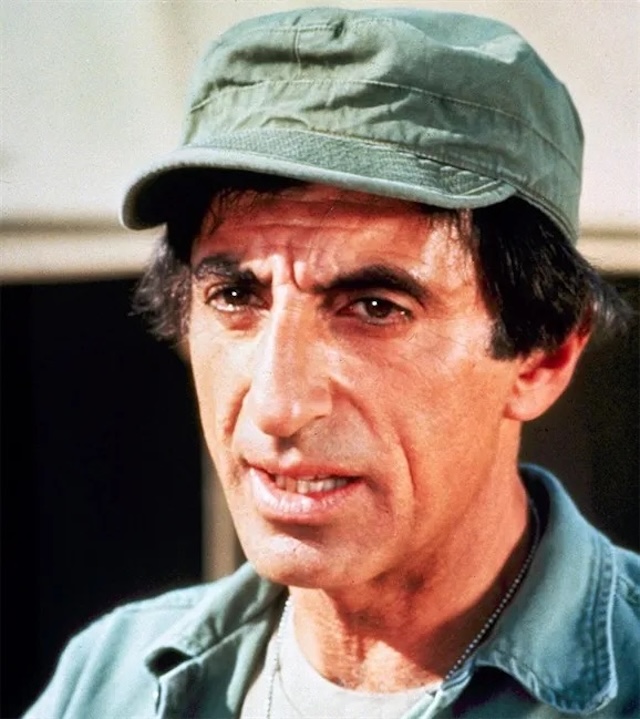 A shot of Jamie Farr as Klinger, showing his resilience as a soldier trying to escape the war through any means necessary—usually involving his creative wardrobe choices.