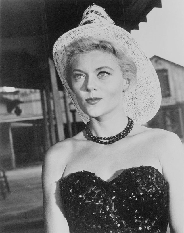 Peggie Castle as Lily Merrill, the strong-willed saloon owner who provides wisdom and guidance to the lawmen while running the Birdcage Saloon