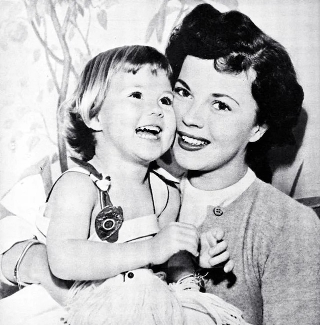 In this beautiful photo, Shirley Temple and her daughter Linda laugh together, capturing the innocence and joy of their relationship