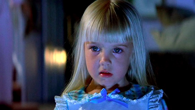 Carol Anne's fearful expression as she faces the supernatural elements, highlighting the innocence amidst the horror in "Poltergeist.