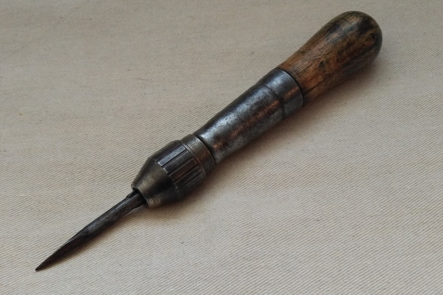 A robust metal-bodied vintage awl, built to last with an ergonomic handle