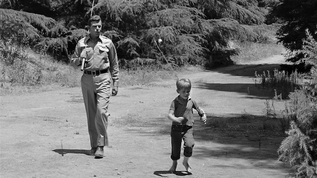 Sheriff Andy Taylor and Opie walk barefoot with their fishing poles, a nostalgic image from The Andy Griffith Show, representing the simple, wholesome life in Mayberry