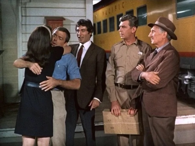 Sam Jones receives a warm welcome at the train station in Mayberry R.F.D., surrounded by familiar faces from Mayberry, including Andy Taylor