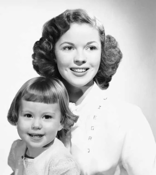 A classic studio portrait of Shirley and little Linda Susan, capturing their grace and timeless beauty.