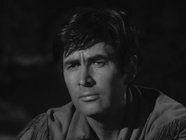 A close-up shot of Fess Parker captures his thoughtful, determined expression, a hallmark of his portrayal of the iconic frontiersman