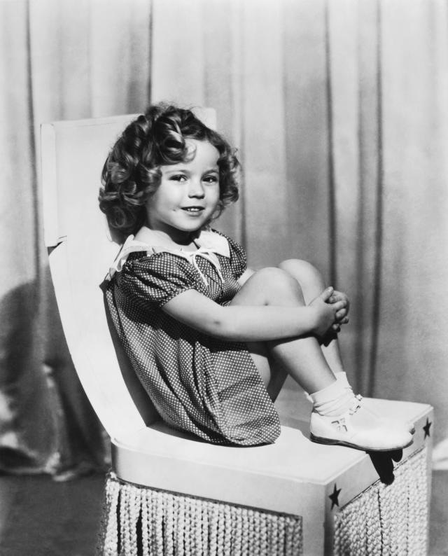 A beautiful studio portrait of Shirley Temple, exuding both charm and grace, highlighting her early career