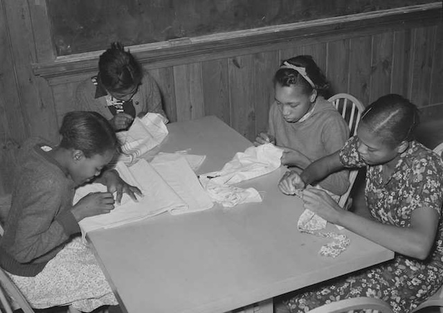 Students focus intently on their sewing tasks, perfecting stitches and techniques under the guidance of their Home Economics teacher.