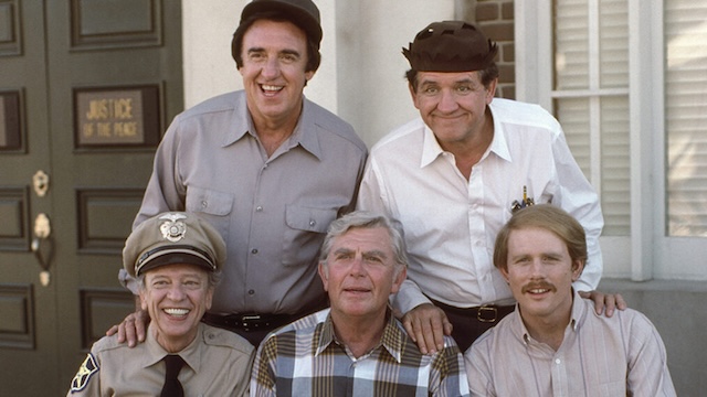 A joyous reunion of The Andy Griffith Show cast members, including Don Knotts, Andy Griffith, Jim Nabors, and Ron Howard, capturing their enduring camaraderie both on and off-screen