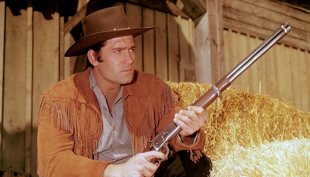 Clint Walker prepares for action as the strong, silent sheriff in a small Western town.