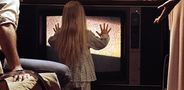 Carol Anne reaches out to the TV, in one of the most iconic and eerie moments from "Poltergeist.