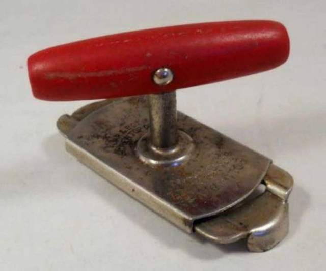 A well-preserved vintage jar opener with a classic red handle, designed for easy and efficient jar opening.