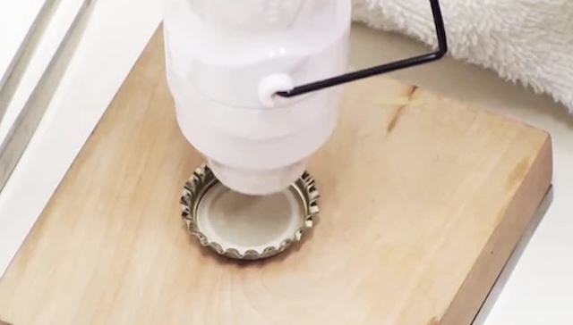 A close-up of the process of adding a rubber liner inside a bottle cap, crucial for sealing in carbonation and maintaining freshness.