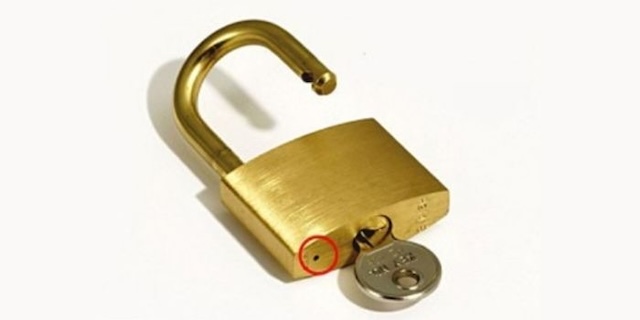 A padlock with the drainage hole exposed, ensuring the internal mechanism stays dry and functional.