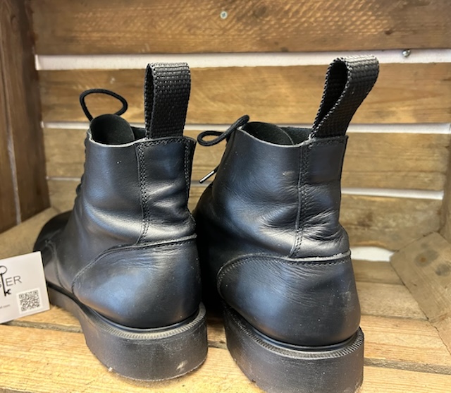 Sturdy pull tabs on leather boots, perfect for quickly slipping them on and off, especially with snug-fitting footwear.