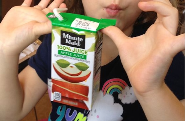 Holding the juice box by the flaps is a handy way for kids to avoid squeezing and spilling their drink.