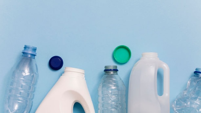 Plastic bottles and containers marked with recycling symbols, indicating the type of plastic used.