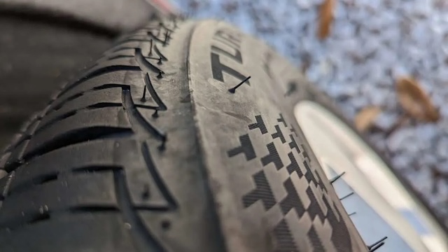 A close-up shot of a new tire showing tiny rubber hairs, known as tire whiskers, which are formed during the tire manufacturing process.