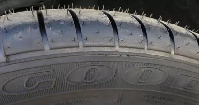 A detailed look at the tire surface from the Goodyear brand, with visible rubber spikes, an indicator of the tire being fresh out of the mold.