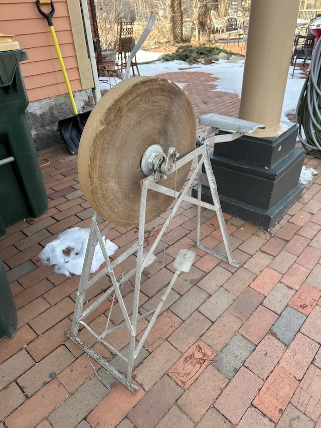 A relic from the past, this pedal-driven grinding wheel still holds rustic charm