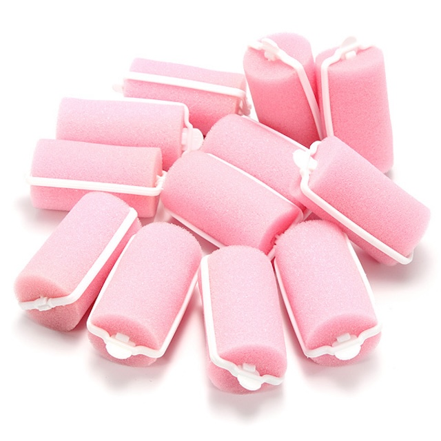 A collection of classic foam hair rollers in their signature pink. Soft, squishy, and comfortable enough to sleep in, these were the go-to for effortless curls