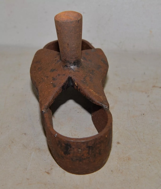 The sturdy handle of the antique shoe sole cutter, once gripped by skilled hands to craft leather soles with precision