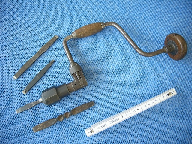 An antique hand drill brace, complete with interchangeable bits, ready to tackle any woodworking project of the past