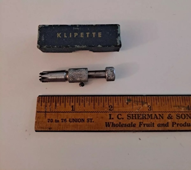 The vintage nose hair trimmer with its original box labeled "Klipette," alongside a ruler for size reference.